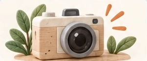 A felt camera among leaves.